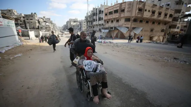 Palestinian residents, carrying their personal belongings with them