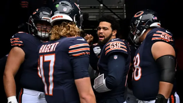 Chicago Bears quarterback Caleb Williams talks to his teammates