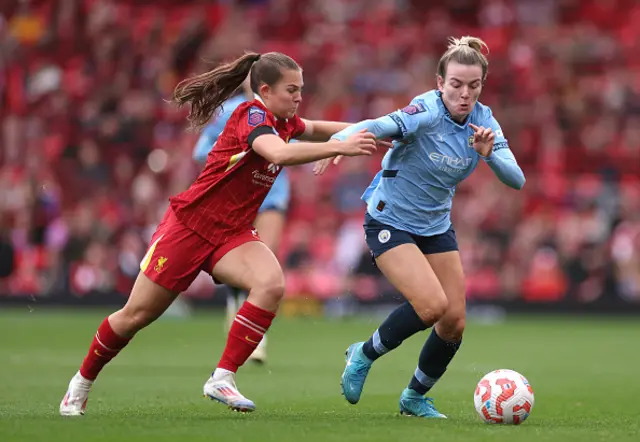 Lauren Hemp of Manchester City is challenged by Lucy Parry