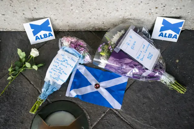 Flowers and flags outside the Scottish Parliament