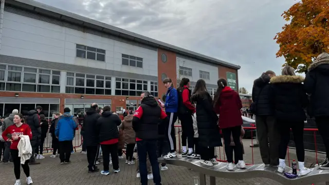 Manchester United fans outside Leigh Sports Village