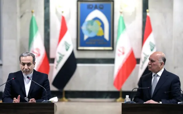 Iranian foreign minister Abbas Aragchi, left, speaks alongside his Iraqi counterpart, Fuad Hussein, at a joint press conference in Baghdad