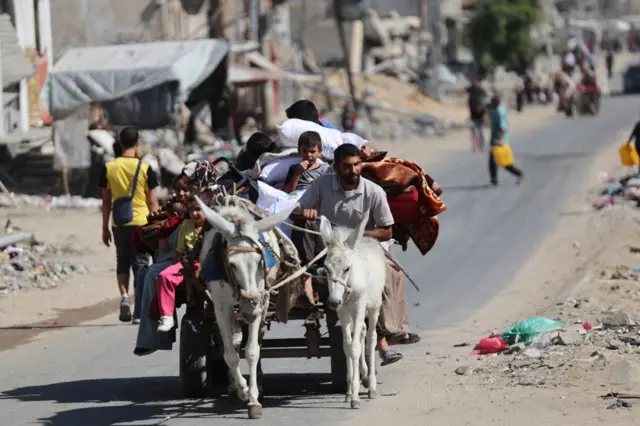 Palestinians transport their belongings as they flee from north of Gaza city