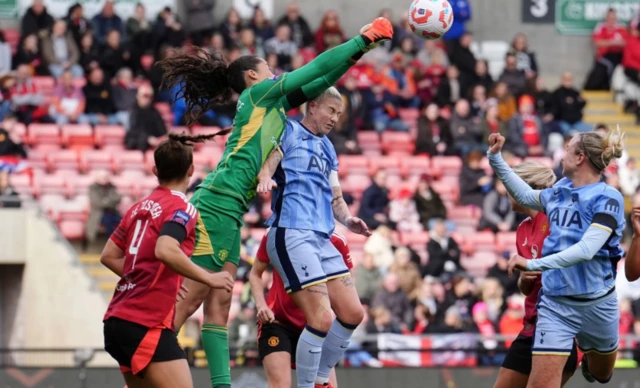 Manchester United goalkeeper Phallon Tullis-Joyce punches the ball