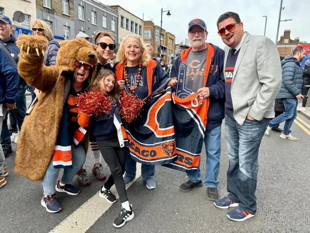 Chicago Bears fan, including one in a bear coat, left