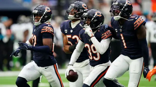 Chicago players celebrate making an interception