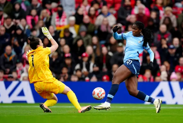 Khadija Shaw (right) attempts a pass Liverpool goalkeeper Rachael Laws