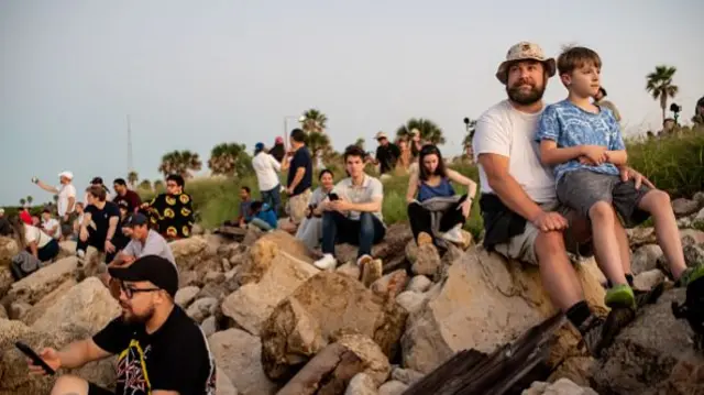 People await the rocket's launch near Boca Chica, in Texas