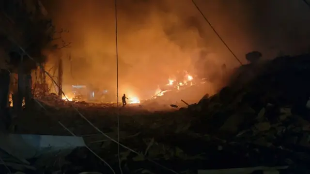 A rescuer searches for survivors at the site of an Israeli airstrike that targeted the southern Lebanese city of Nabatieh