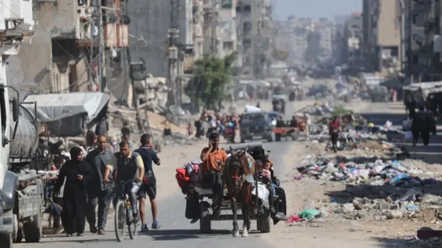 Palestinians transport their belongings as they flee areas north of Gaza City in the northern Gaza Strip