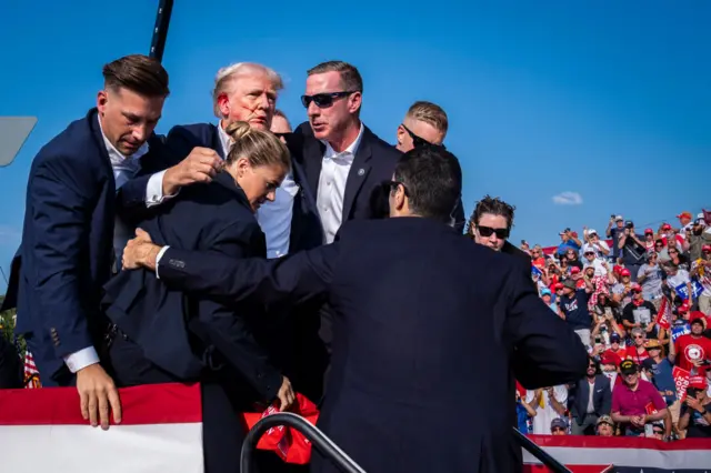 Donald Trump exits the stage from a rally in Pennsylvania after an assassination attempt