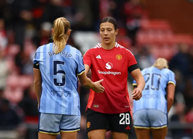 Tottenham Hotspur's Molly Bartrip shakes hands with Manchester United's Rachel Williams