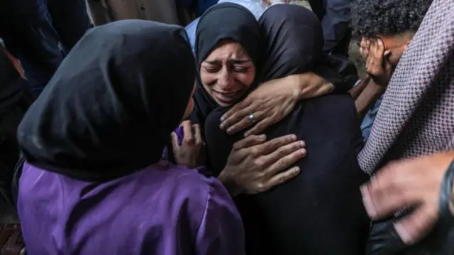 A grieving family at the Nuseirat camp on Monday