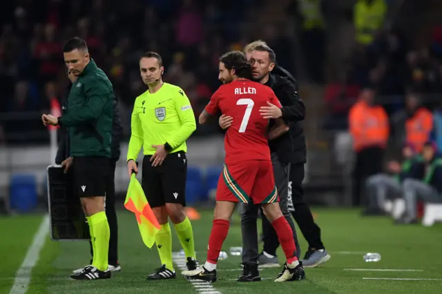 Joe Allen gets a hug from Craig Bellamy as he comes on