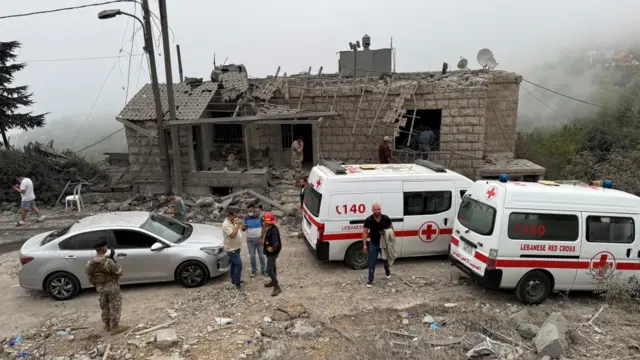 Lebanese Red Cross vehicles parked near the site of the strike in Aitou