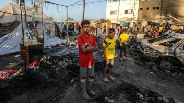 Two boys stand among rubble after an air strike hit Al-aqsa Hospital in central Gaza.