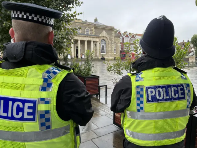 Two police officers look at Salisbury Guildhall