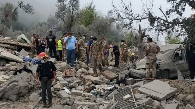 Lebanese emergency teams, soldiers and civilians conduct a search and rescue operations after Israeli airstrikes on village of Aitou