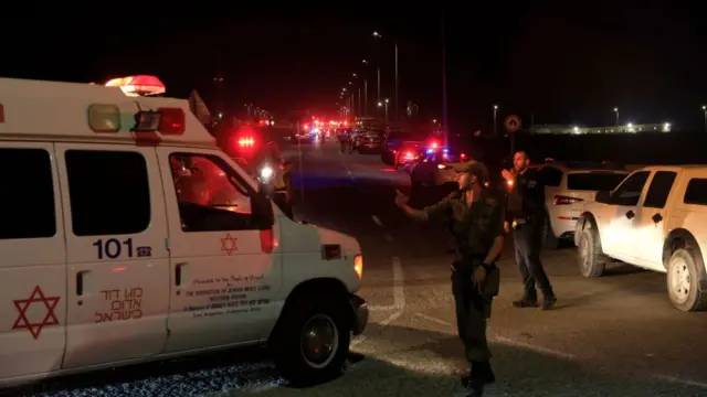 Emergency services personnel attend the scene of a drone strike on October 13, 2024 in Binyamina, Israel.