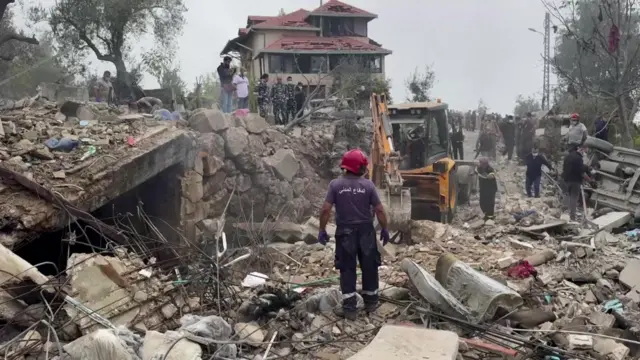 Rescue workers at the scene of an air strike in Aitou, Lebanon on Monday