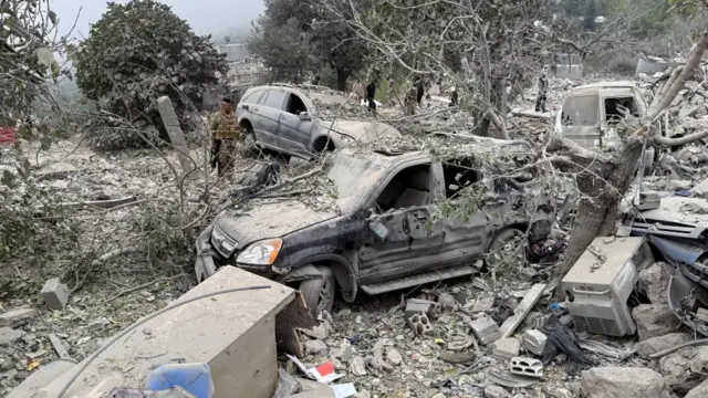 Destroyed vehicles at the scene of the strike in northern Lebanon