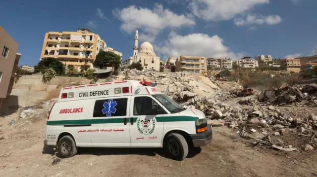 Lebanese civil defence ambulance parked in middle of debris in Ain Deleb after Israeli strike