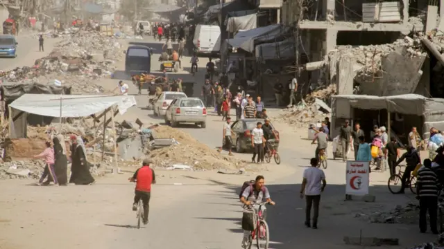 Palestinians carry their belongings as they flee areas north of Gaza City in the northern Gaza Strip