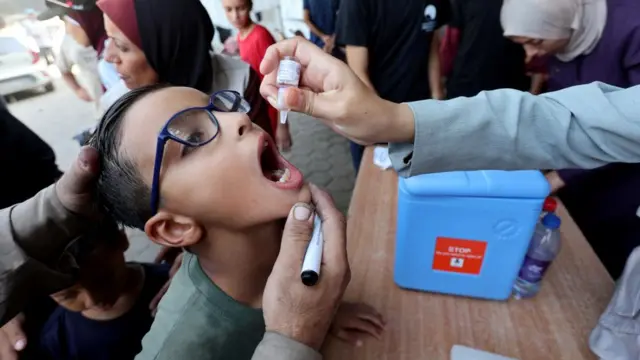 Palestinian child is vaccinated against polio during the second round of a vaccination campaign, amid the Israel-Hamas conflict, in Deir Al-Balah