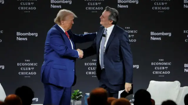 Trump shakes hands with John Micklethwait, editor-in-chief of Bloomberg News