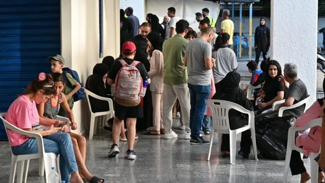 Lebanese wearing everyday clothes gathering under a building