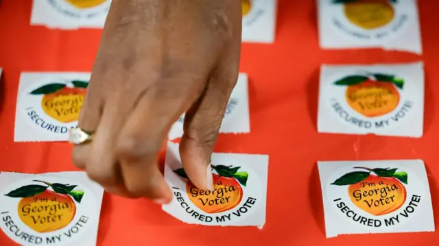 A poll worker arranges stickers during the Georgia Presidential Primary election in March