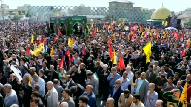 Huge crowds holding various flags