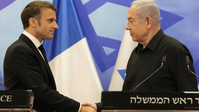 Macron, left, and Netanyahu shake hands