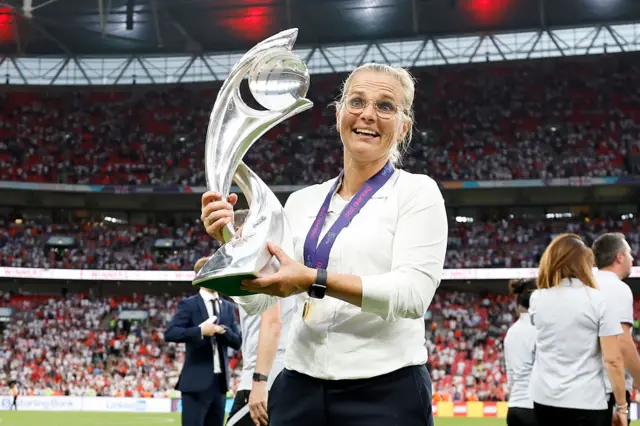 Sarina Wiegman holding the 2021 Women's Euro trophy