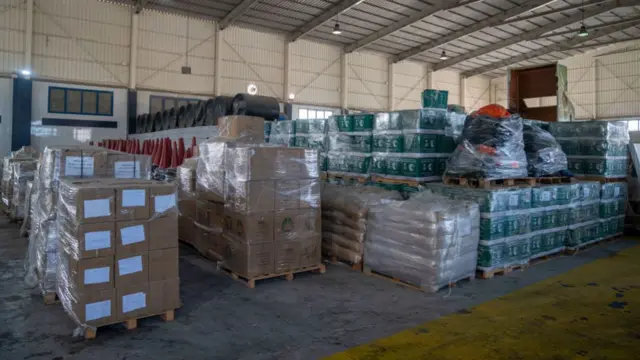 Several boxes of aid being stored in a warehouse