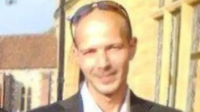 Charlie Rowley wears a suit and he has sunglasses on top of his head