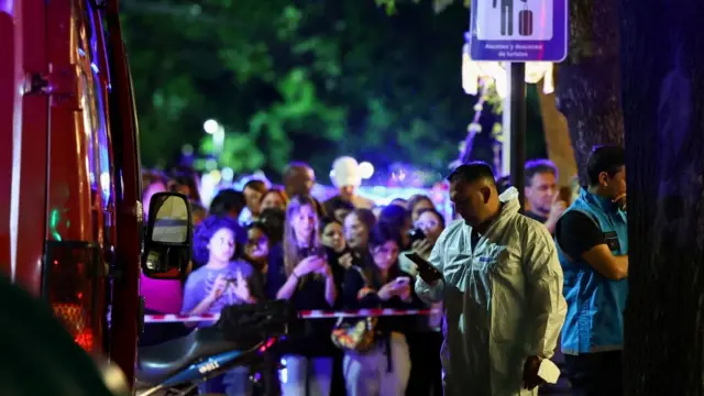 A forensic technician uses his phone outside the hotel where Liam Payne, former One Direction member, was found dead