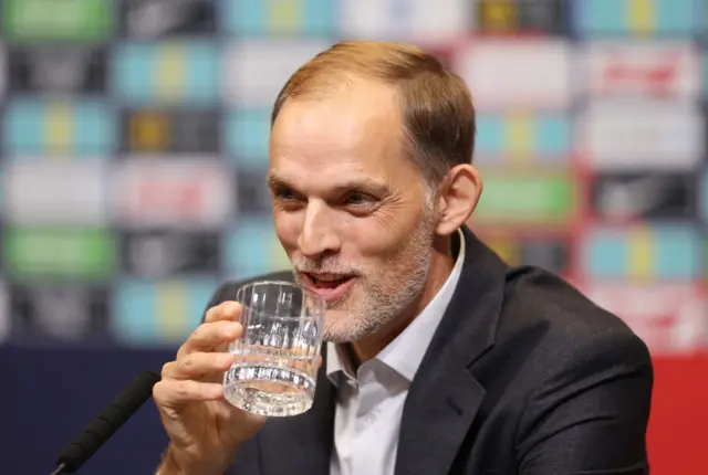 Thomas Tuchel taking a sip of water at a press conference