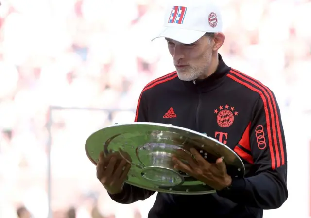 Thomas Tuchel looking at the Bundesliga trophy