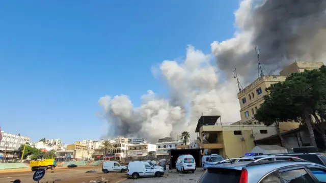 Smoke billows over Nabatieh, which was hit by an Israeli airstrike earlier today