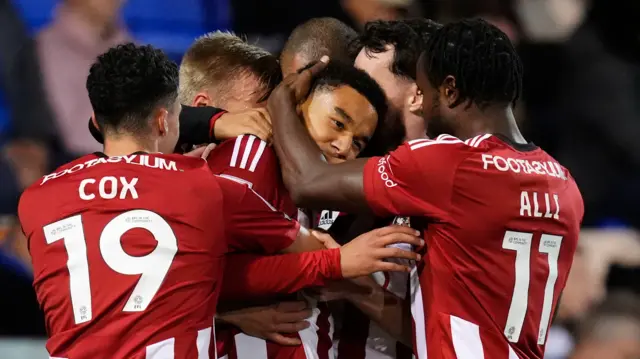 Exeter players celebrate with goalscorer Kamari Doyle