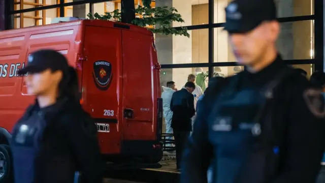 Police stand guard outside the hotel