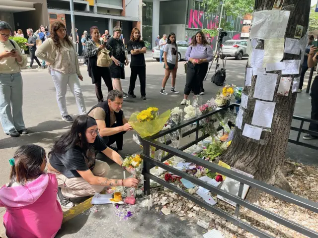 Fresh flowers and notes are laid at the site of Payne's death. Vigils are planned in Buenos Aires city centre, as well as at the hotel.