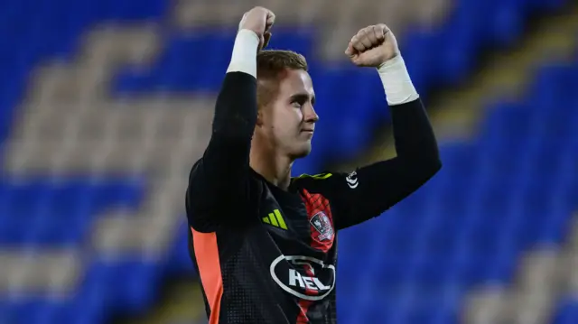 Exeter goalkeeper Joe Whitworth celebrates at full-time after victory over Shrewsbury