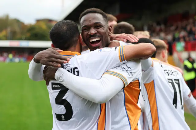 Shrewsbury Town defender Aristotle Nsiala celebrates