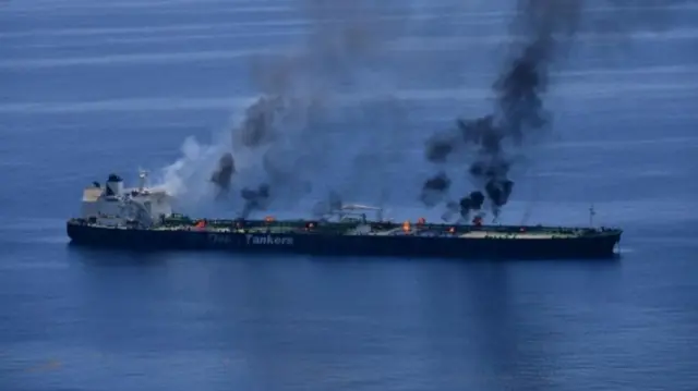 Large oil tanker on fire in several part of the vessel with plumes of smoke rising, taken August 2024