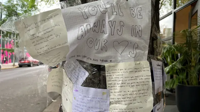 Letters pinned outside hotel, one saying "You'll always be in our hearts"