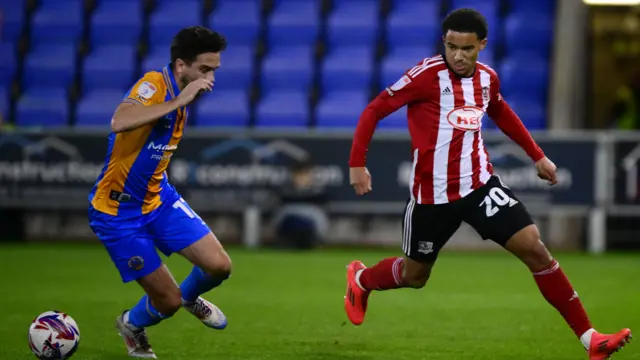 Exeter goalscorer Kamari Doyle takes on Shrewsbury's Alex Gilliead