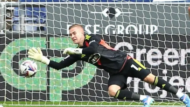 Exeter goalkeeper Joe Whitworth making a save