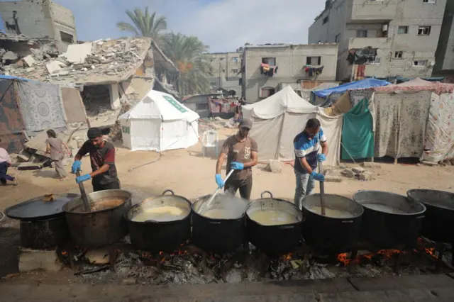 Hot meals are distributed by a charity group in Gaza City.